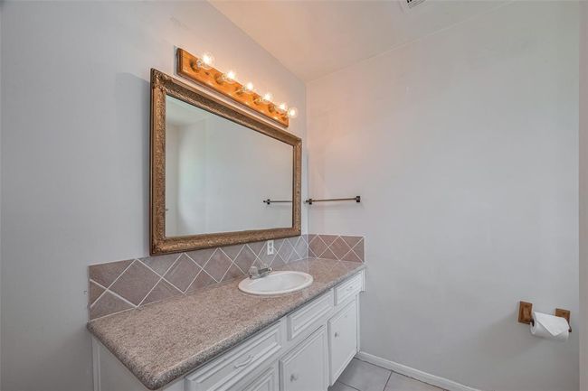 Primary bathroom featuring a spacious vanity with a granite countertop. | Image 21