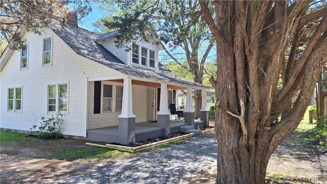 View of front of house with roof with shingles and covered porch | Image 5