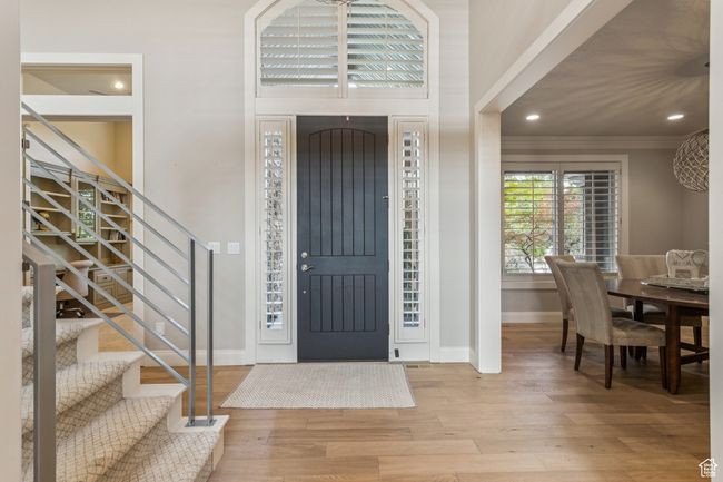 Foyer entrance featuring wood finished floors, stairs, crown molding, and recessed lighting | Image 24