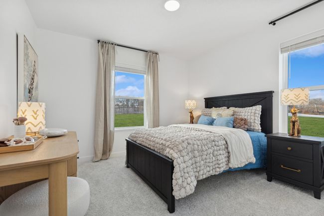(Photo of a decorated model, actual homes finishes will vary) One of three generously sized secondary bedrooms with a spacious closet! | Image 13