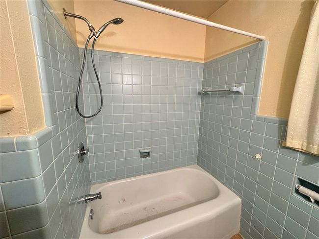 Bathroom featuring tiled shower / bath combo | Image 29