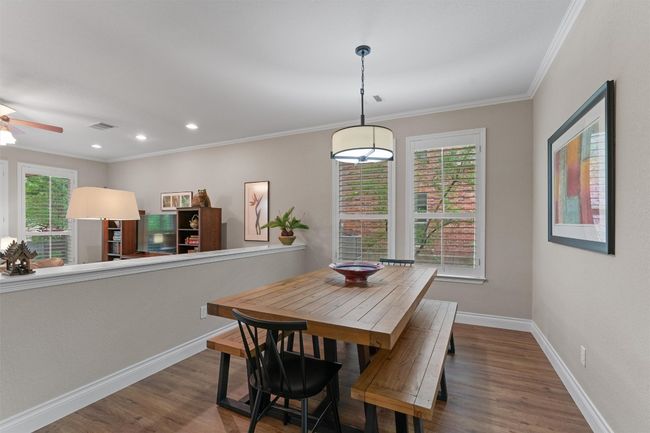 Dining room featuring wood finished floors, ornamental molding, baseboards, a ceiling fan, and recessed lighting | Image 5