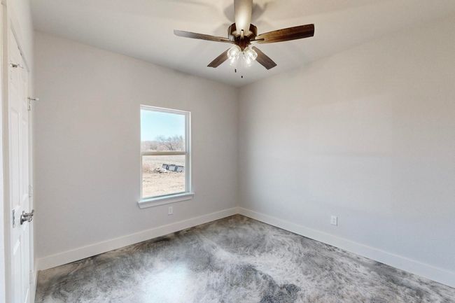 Unfurnished room with baseboards and a ceiling fan | Image 27