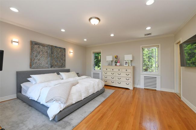 Bedroom featuring ornamental molding, baseboards, recessed lighting, and wood finished floors | Image 11