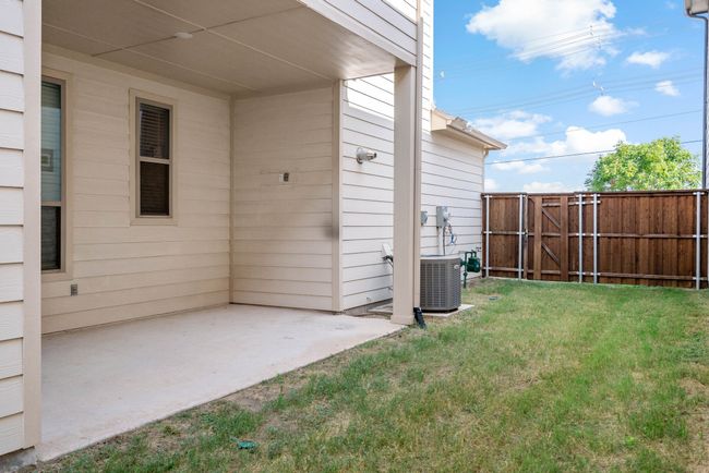 View of yard with a gate, central AC unit, fence, and a patio | Image 33