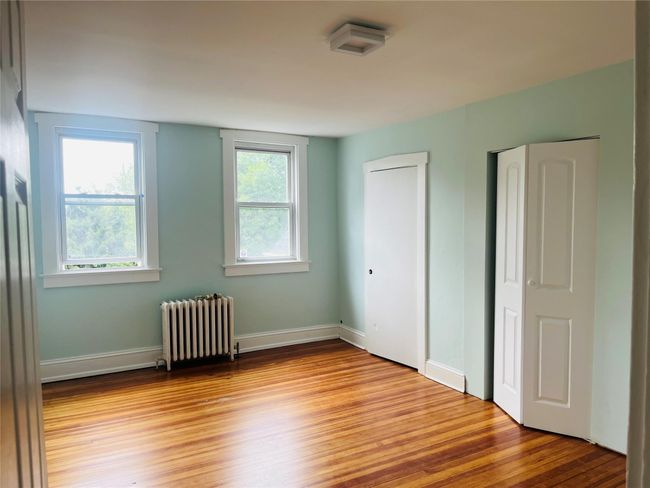 Large bedroom with double closets and wood floor | Image 11