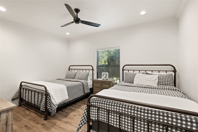 Bedroom featuring wood finished floors, ornamental molding, recessed lighting, and ceiling fan | Image 28