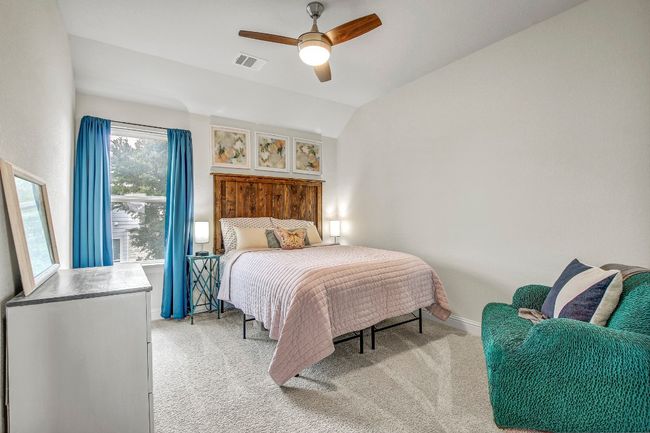 Bedroom featuring light carpet, lofted ceiling, and ceiling fan | Image 28