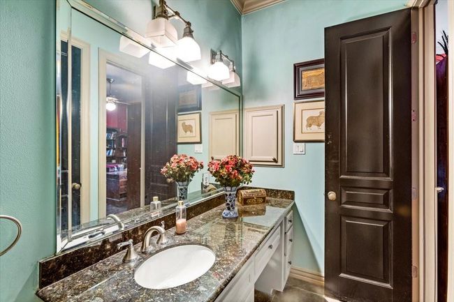 Full bathroom inside the study blends coastal colors with English Manor charm. | Image 23