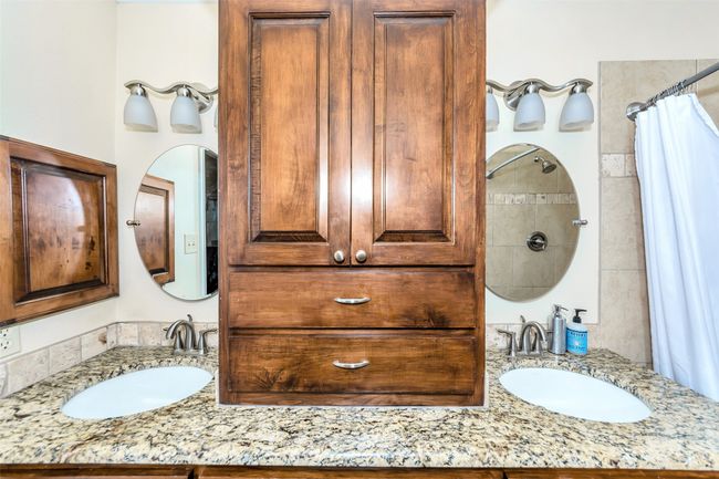 Bathroom with vanity and a shower with shower curtain | Image 24