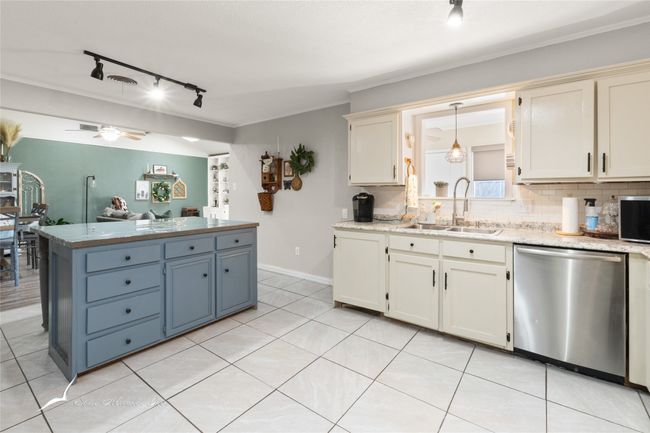 Kitchen featuring track lighting, a sink, stainless steel appliances, a ceiling fan, and backsplash | Image 11
