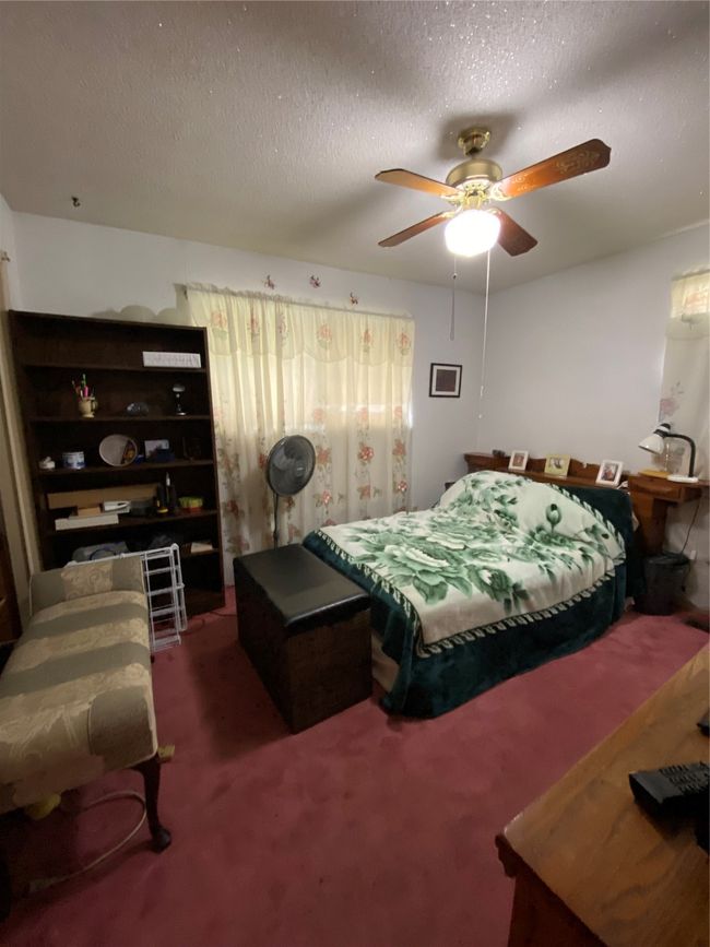 Carpeted bedroom featuring ceiling fan and a textured ceiling | Image 13