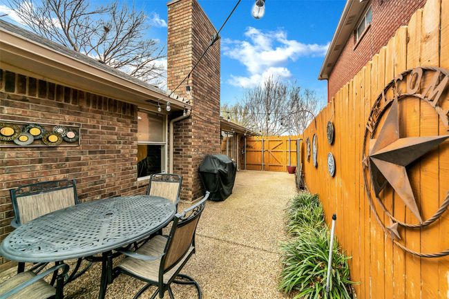 View of patio / terrace with grilling area, a gate, and outdoor dining area | Image 33