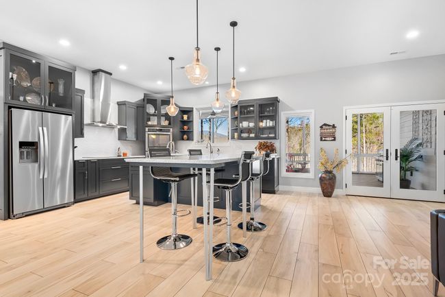 Modern interior with gourmet kitchens and spa like living spaces! Kitchen Island, Pendant Lighting, Induction Cooktop and top of the line appliances! | Image 9