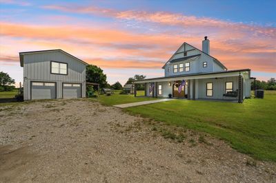 Modern inspired farmhouse with central AC, a yard, covered porch, and a garage | Image 2