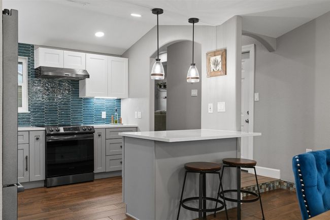 A breakfast bar sits at the heart of the kitchen, ready for family gatherings, casual meals, or simply a spot to unwind with a cup of coffee | Image 10