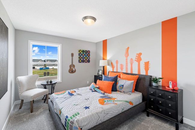 (Photo of a decorated model, actual homes finishes will vary) The second generously sized upper level secondary bedroom with a spacious closet. | Image 14