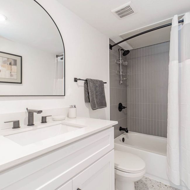 Full bathroom with vanity, shower / bathtub combination with curtain, toilet, and visible vents | Image 12