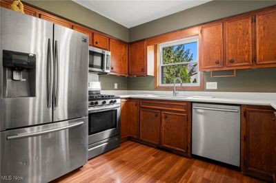 Kitchen with sink, stainless steel appliances, and light wood-type flooring | Image 3