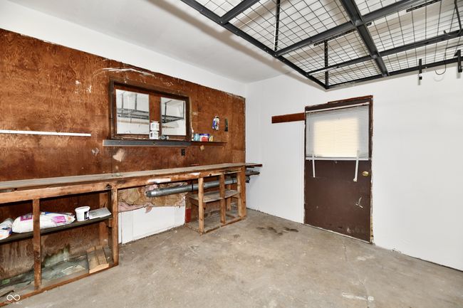 Workbench in the workshop, storage rack mounted on ceiling remains with home. | Image 38