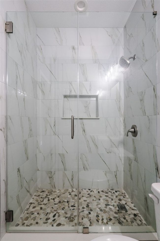 Full bath featuring a marble finish shower and toilet | Image 18