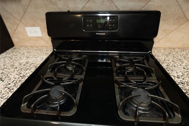 Kitchen view of black range with gas cooktop and decorative backsplash | Image 35