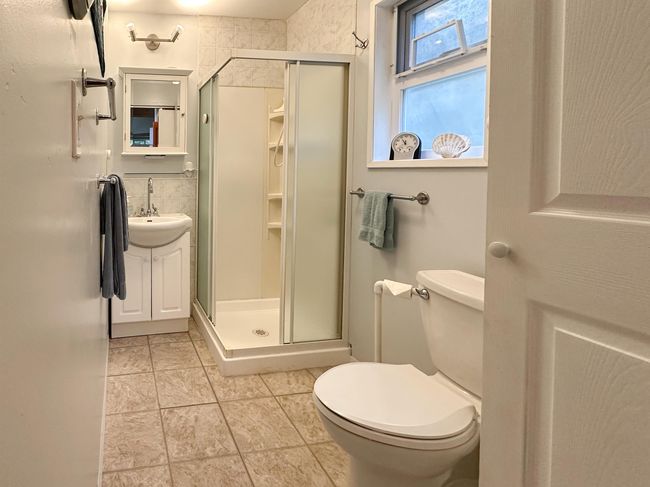 Full bath with toilet, vanity, tile walls, and a shower stall | Image 17