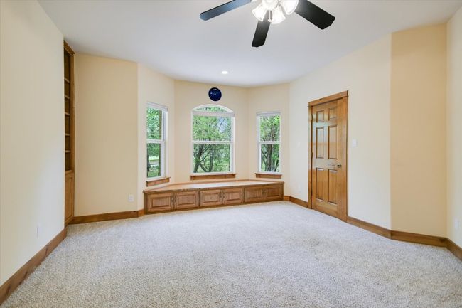 Bedroom #4 Warm wood tones, soft arches, natural lighting, large closet, bay windows & seating and built in bookshelves & Trophy Display! | Image 19