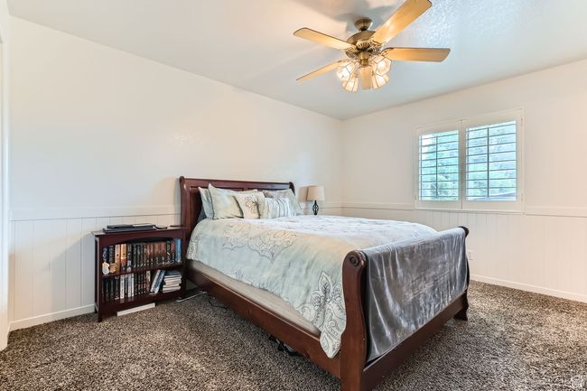 Carpeted bedroom featuring a wainscoted wall and a ceiling fan | Image 10