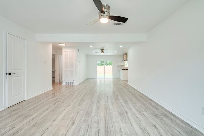 Unfurnished living room with a ceiling fan, light wood-style flooring, and recessed lighting | Image 5