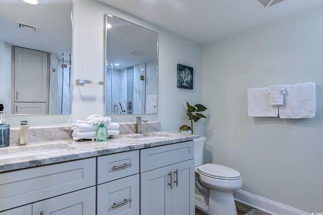 Bathroom with vanity, toilet, and an enclosed shower | Image 27
