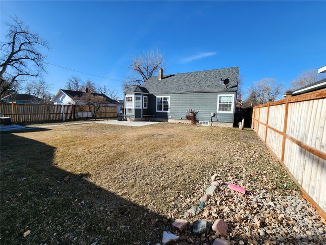 Back of house featuring a lawn, a shingled roof, a fenced backyard, and a patio area | Image 8