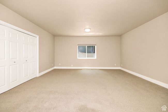Unfurnished bedroom featuring carpet, baseboards, and a closet | Image 33