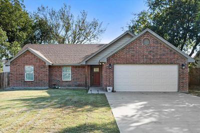 View of front of home featuring a front lawn and a garage | Image 1