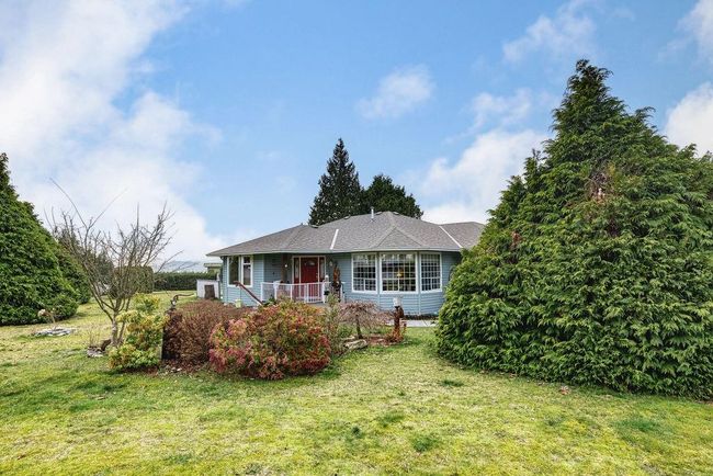 Single story home featuring a front yard and covered porch | Image 29