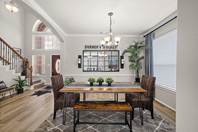 Another view of dining room leading into entry foyer. | Image 17