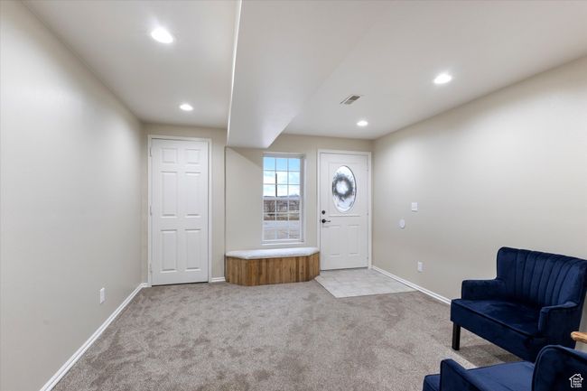 Foyer entrance with vault, recessed lighting, light carpet, and baseboards | Image 23