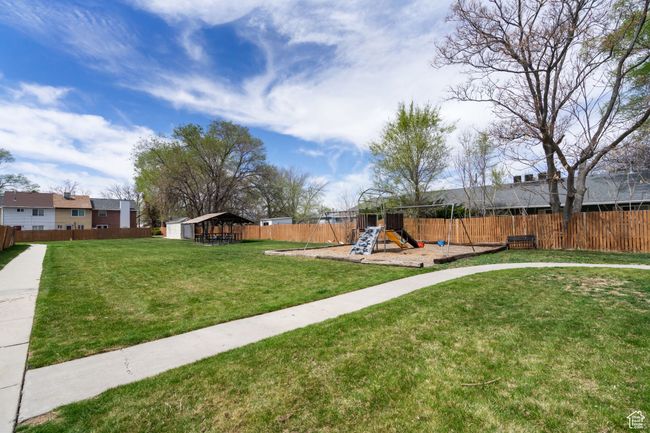 View of yard featuring an outbuilding, a fenced backyard, and a playground | Image 22