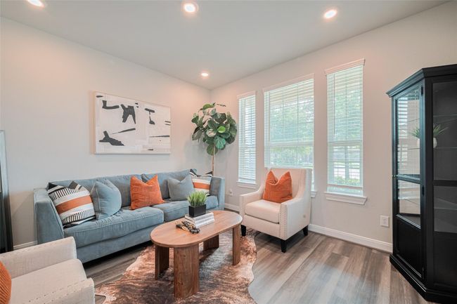 This inviting living room features large windows. | Image 8