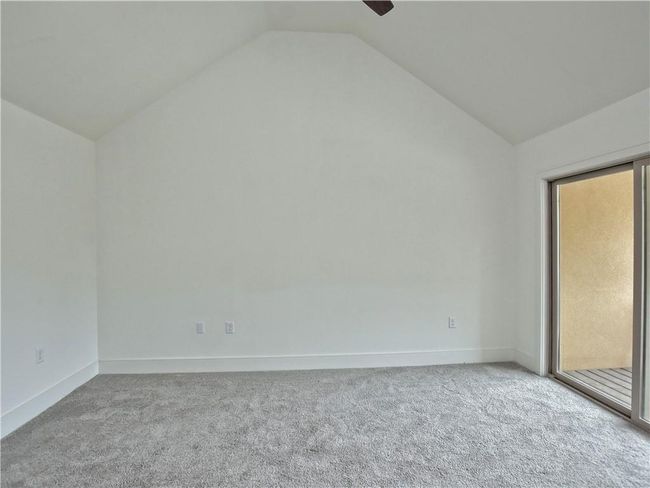 Carpeted spare room with vaulted ceiling | Image 31