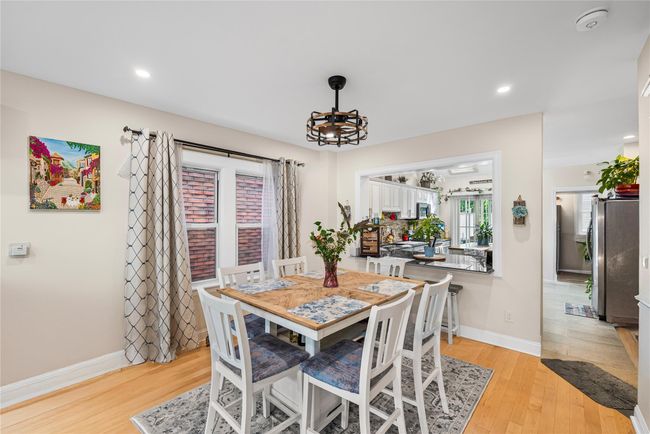 Dining area featuring baseboards, light wood-style flooring, a chandelier, and recessed lighting | Image 5