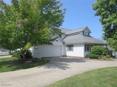 View of front of house with a garage and a front yard | Image 2