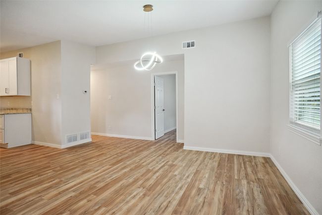 Bright and inviting space featuring light German-engineered floors, an updated chandelier | Image 4
