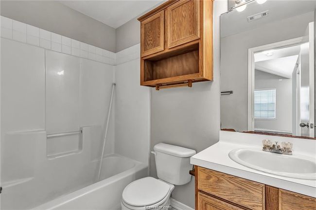 Bathroom featuring vanity and tub / shower combination | Image 10