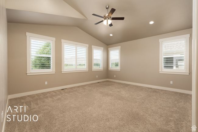 Carpeted spare room featuring vaulted ceiling, ceiling fan, and recessed lighting | Image 22