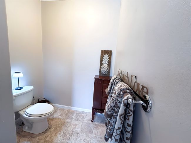 Bathroom featuring toilet and baseboards | Image 26