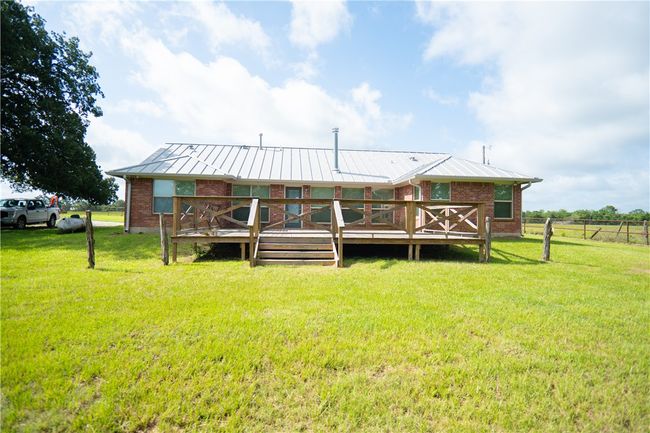 Back of house with a wooden deck and brick siding | Image 15