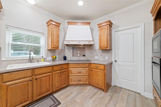 Kitchen with huge island with breakfast bar. | Image 17