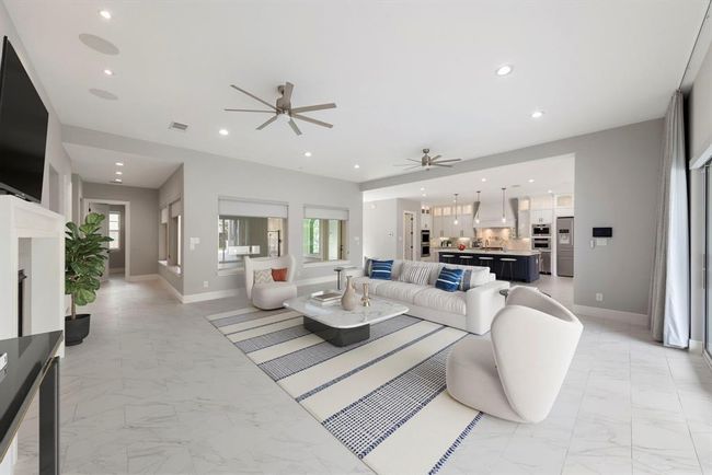 With clean architectural lines, serene neutral tones, and wide sightlines to the kitchen and beyond, this refined living space offers both visual harmony and everyday comfort in a beautifully modern layout. *This photo has been virtually staged.* | Image 17