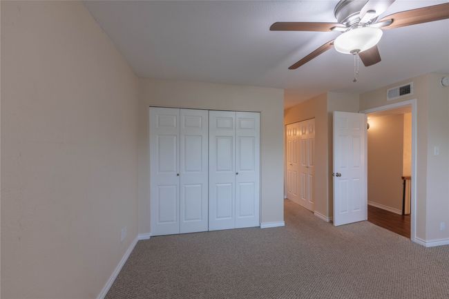 Unfurnished bedroom featuring carpet, baseboards, and ceiling fan | Image 19